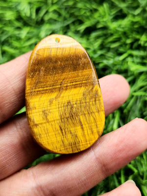 Kwan Yin Carved Pendant in Tiger Eye Gemstone – A Symbol of Divine Feminine Energy and Courage, Offering Emotional Healing, Spiritual Protection, and Inner Strength for the Modern Soul