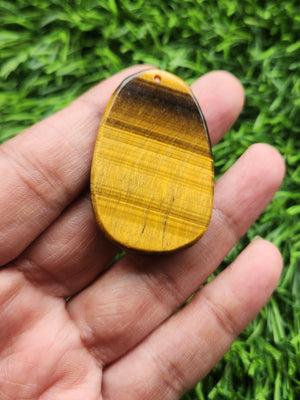 Padmapani Avalokiteshvara Carved Pendant in Tiger Eye Stone – A Sacred Symbol of Compassion, Wisdom, and Protective Strength for Daily Wear, Meditation and Spiritual Empowerment
