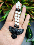 White Moonstone and Black Onyx Bead Mala with Black Onyx Phoenix Pendant - Symbolism and Craftsmanship